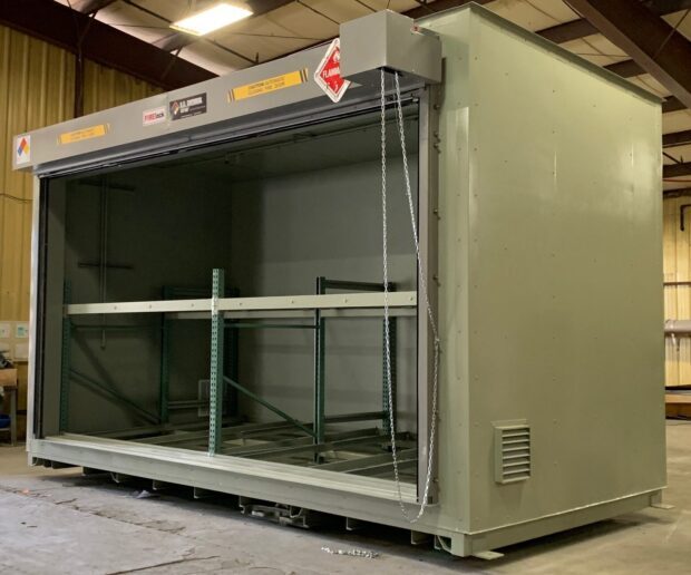 Angled photo of a two-level US Chemical Storage ethanol storage building for a distillery showing the ventilation and manual roll up door